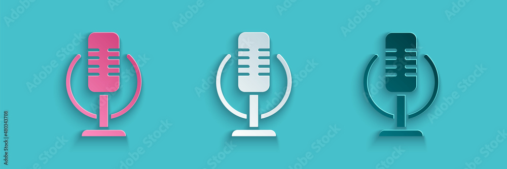 Paper cut Microphone icon isolated on blue background. On air radio mic microphone. Speaker sign. Pa