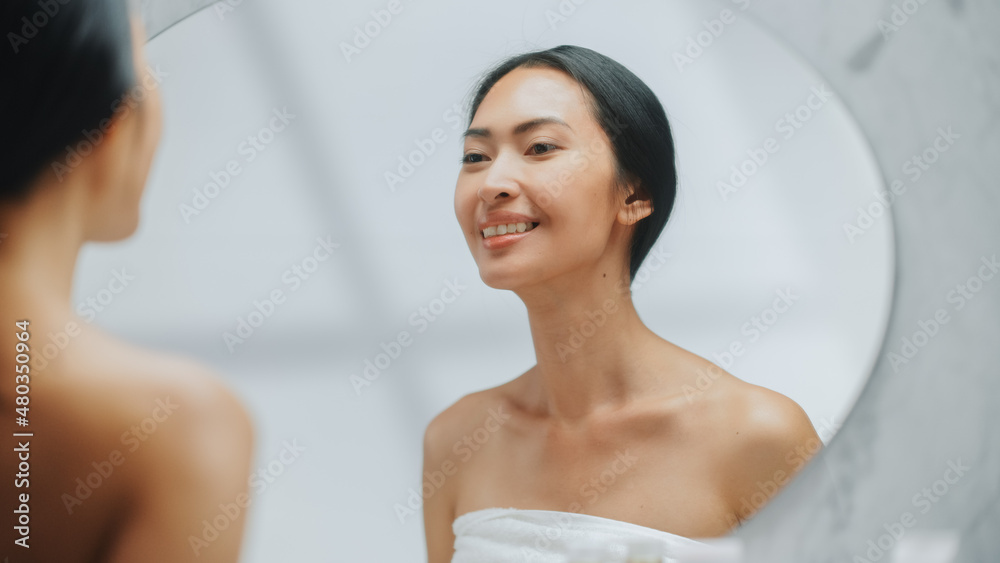 Portrait of Beautiful Asian Woman Checking her Clean Naturaly White Teeth, Smiles in Bathroom Mirror