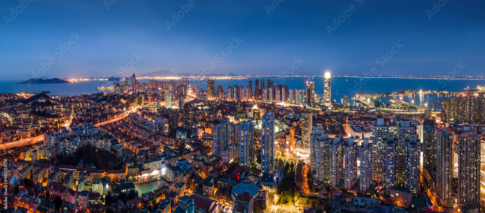 Aerial photography night view of modern city buildings in Qingdao, China