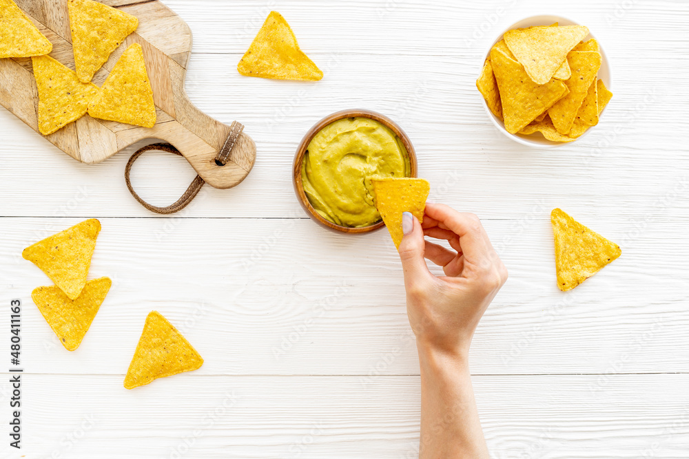 Corn nachos chips with avocado guacamole top view