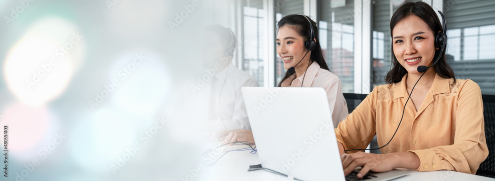 Business team wearing headset working actively in office . Call center, telemarketing, customer supp