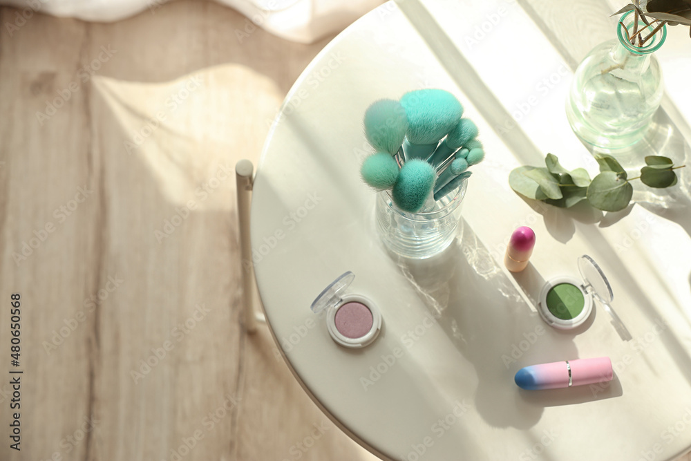 Decorative cosmetics on table in room