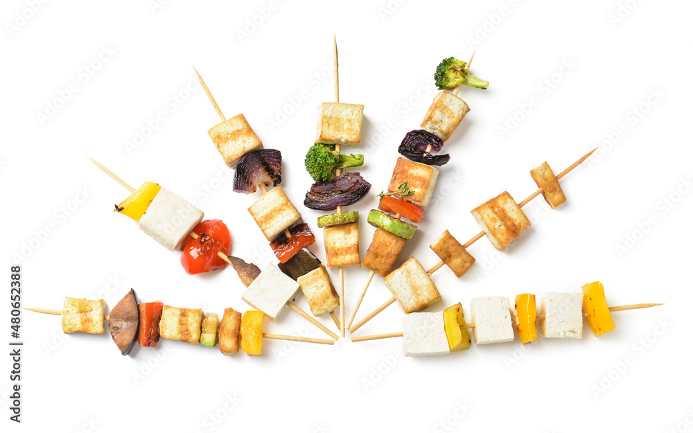 Skewers with tasty tofu cheese and vegetables on white background