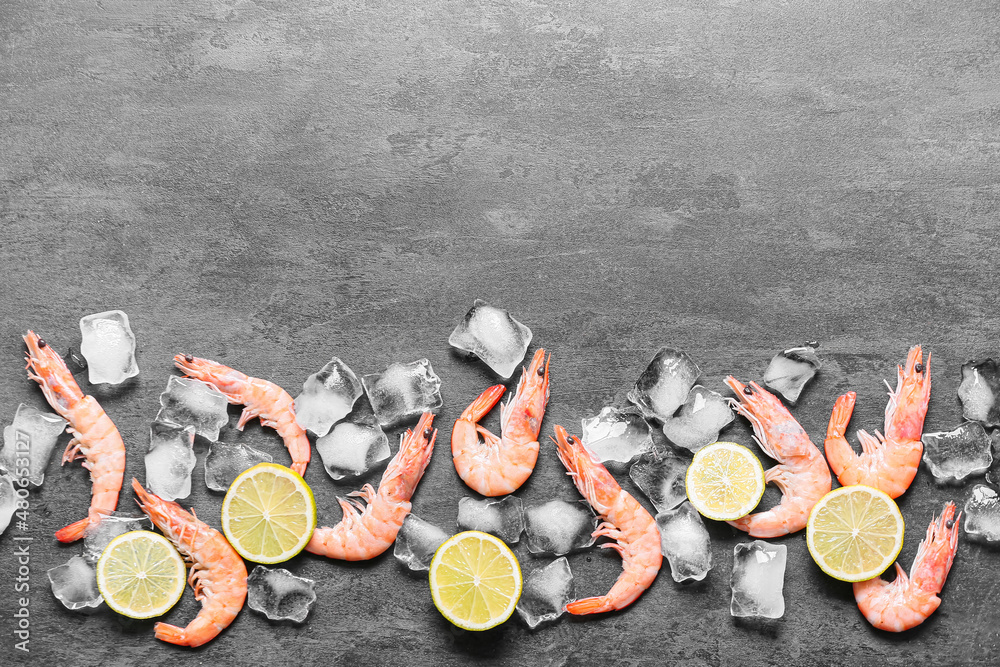 Uncooked shrimps and ice cubes on black background