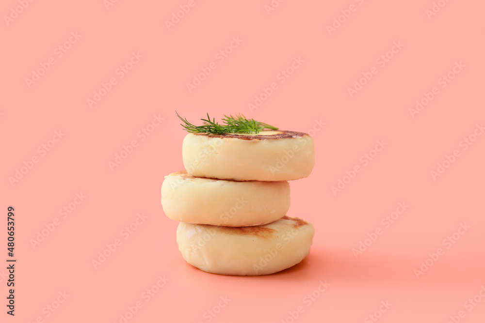 Tasty cottage cheese pancakes on pink background