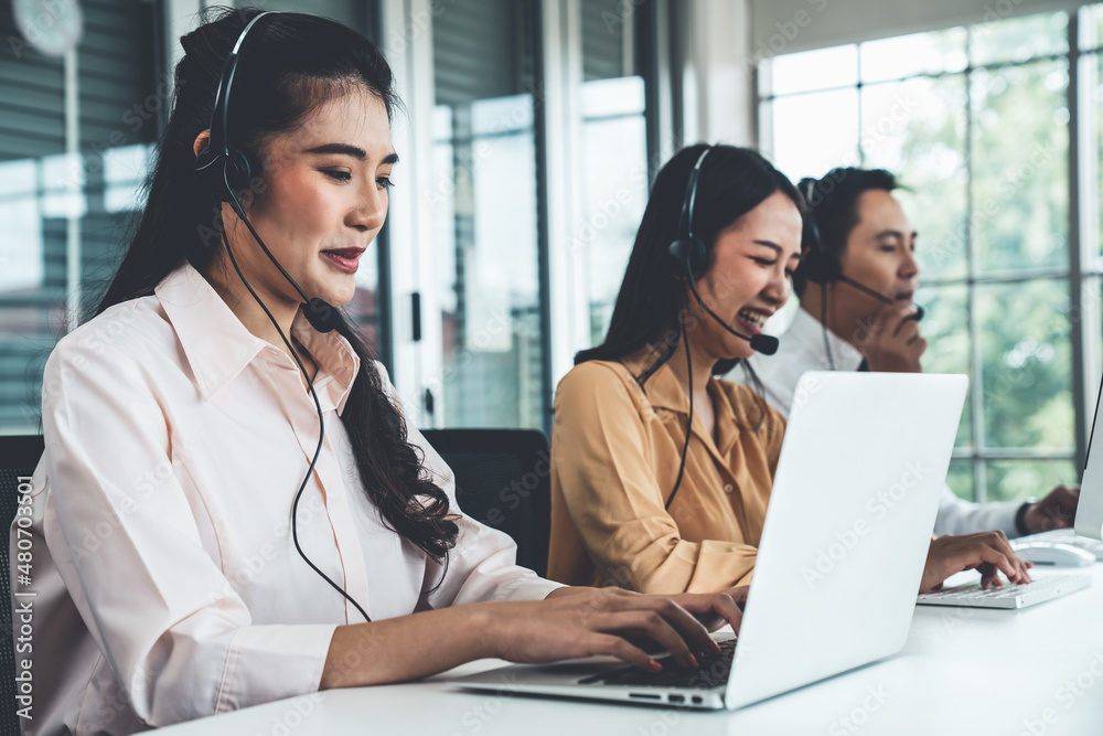 Business people wearing headset working actively in office . Call center, telemarketing, customer su