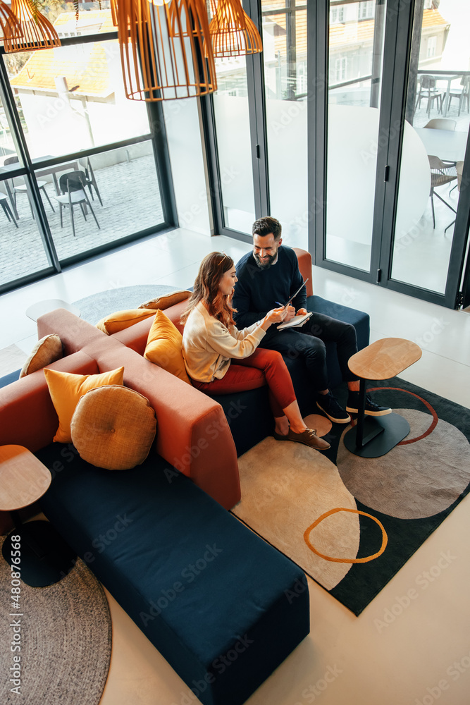 High angle view of two businesspeople working in a lobby