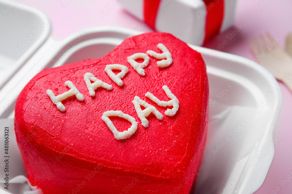 Plastic lunch box with tasty bento cake for Valentines Day on pink background, closeup