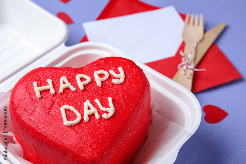 Plastic lunch box with tasty bento cake for Valentines Day on purple background, closeup