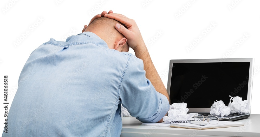 Businessman with stress working on office desk