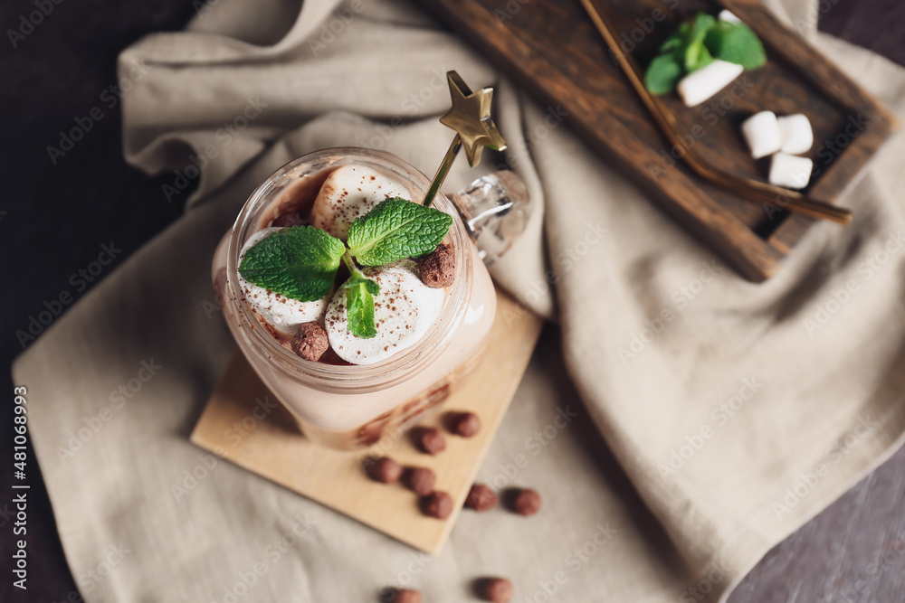 Mason jar of sweet cocoa drink on table