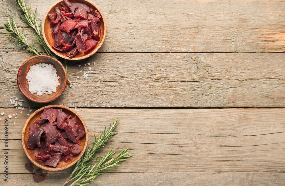 Spicy beef jerky on wooden background