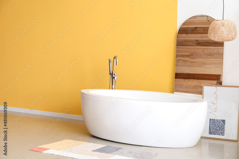 Interior of stylish bathroom with yellow wall