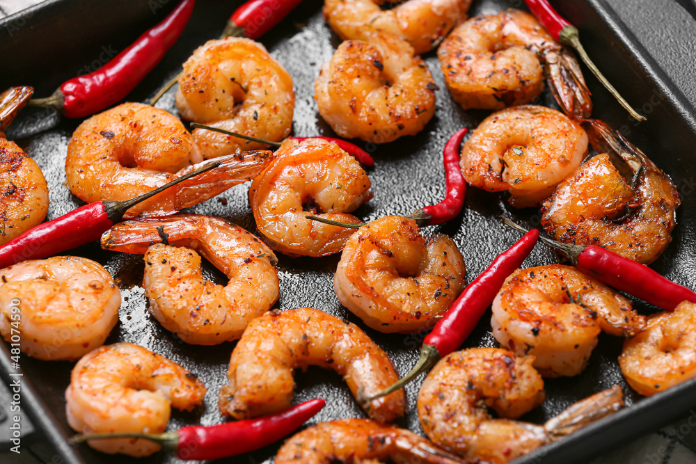 Tasty shrimp tails in baking dish, closeup