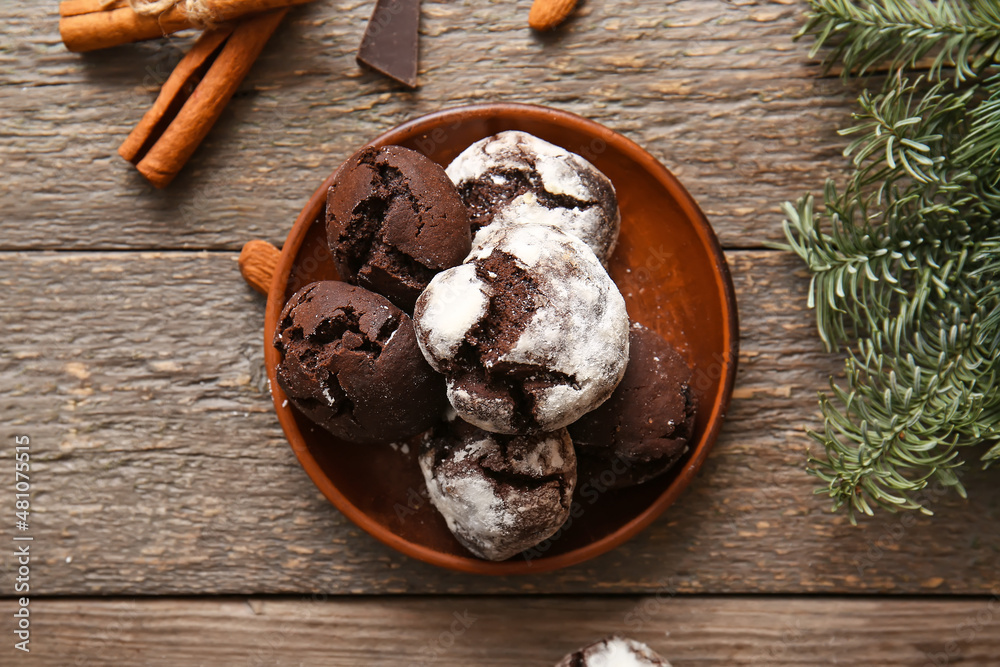 Plate of chocolate brownie cookies on wooden background