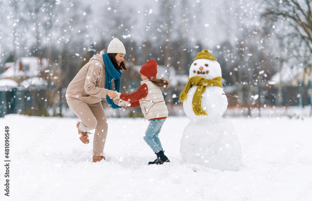 Mother and child girl on a winter walk