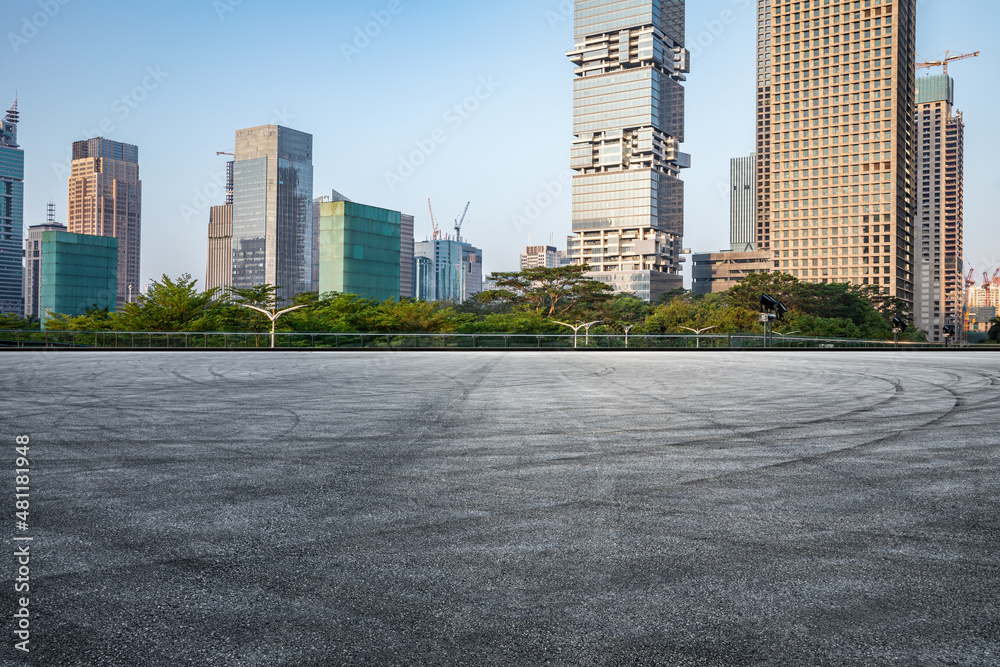 Asphalt road and city skyline with modern commercial buildings in Shenzhen, China.