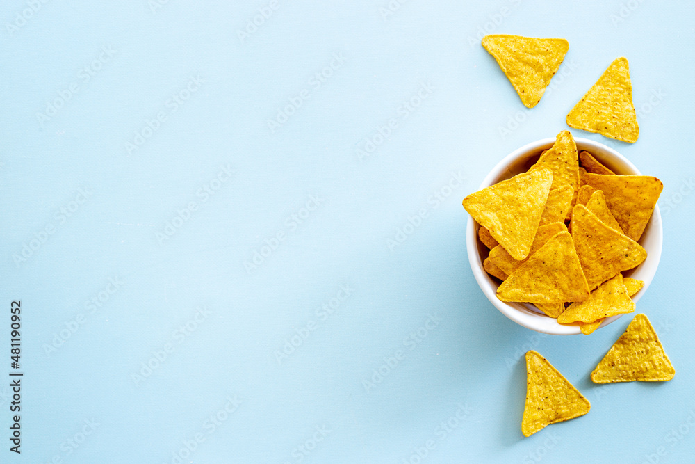 Tortilla nachos chips in bowl. Mexican food background