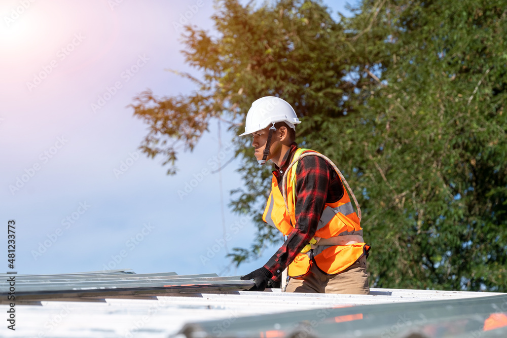 Roofer worker installing new roof on top of the ,Concept of residential building under construction.