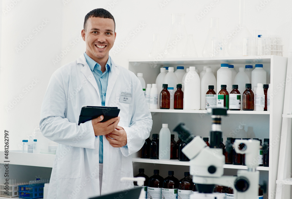 The world will remember his work. Portrait of a confident young scientist working in a modern labora