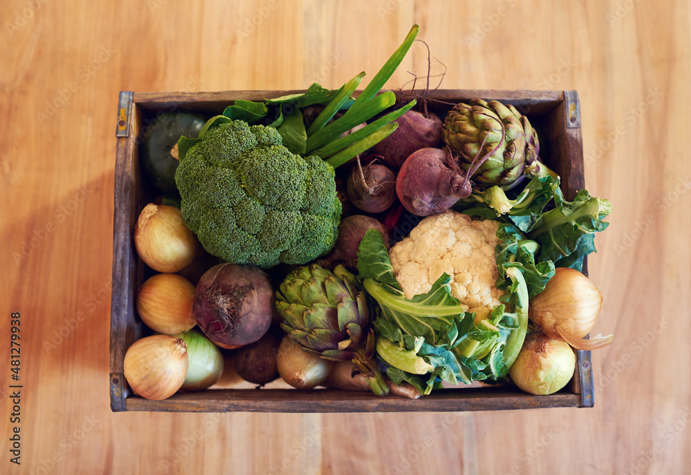 Take your pick of fresh vegetables. Shot of a variety of vegetables in a crate on a table.