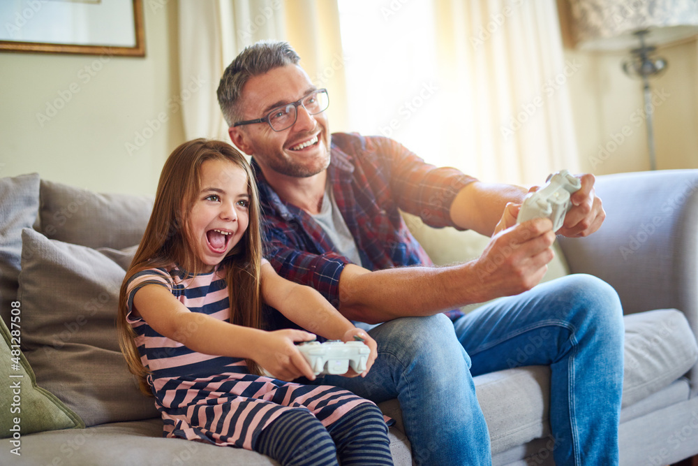 Im beating you dad. Shot of a father and daughter playing video games.