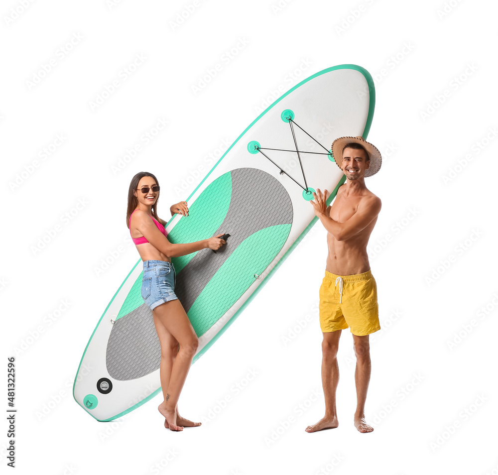 Young couple with board for sup surfing on white background