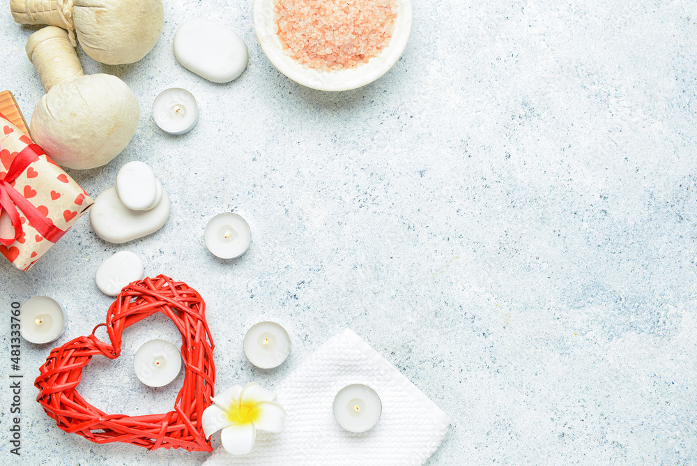 Beautiful spa composition with stones and candles for Valentines Day celebration on light backgroun