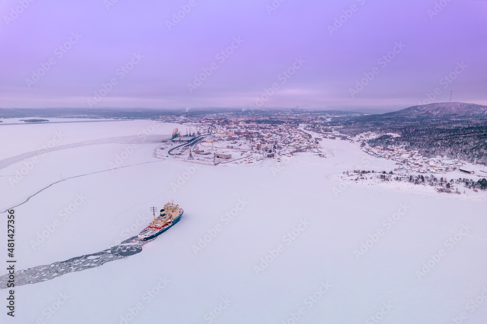 Icebreaking vessel in Arctic with background of sunset