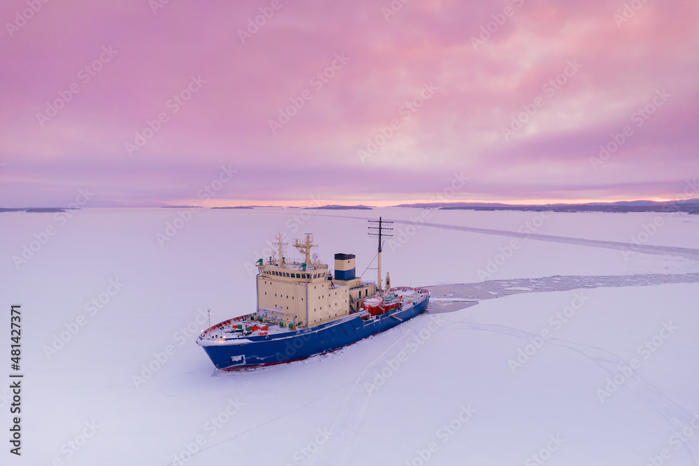 Icebreaking vessel in Arctic with background of sunset