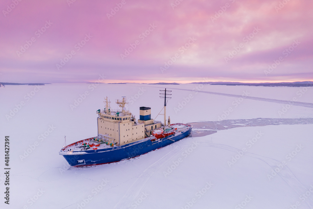 Icebreaking vessel in Arctic with background of sunset