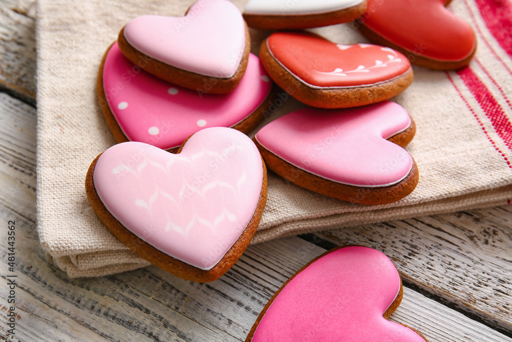 Tasty heart shaped cookies on white wooden background, closeup