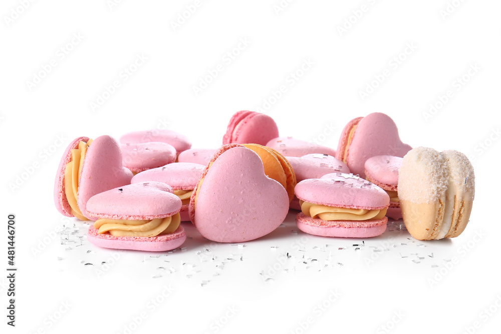 Tasty heart-shaped macaroons on white background