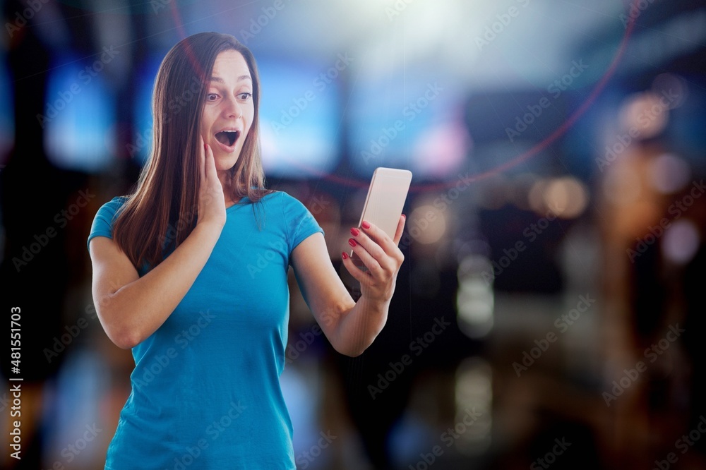 Beautiful Young Woman Using Smartphone Standing on the Night Street