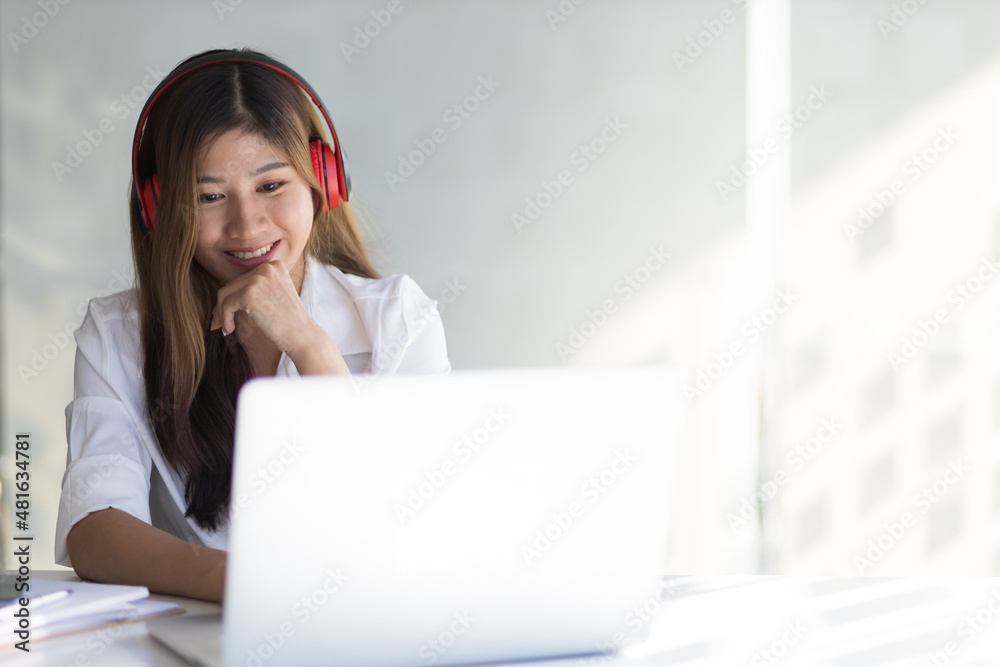 Happy smiling woman working and studying online from laptop.