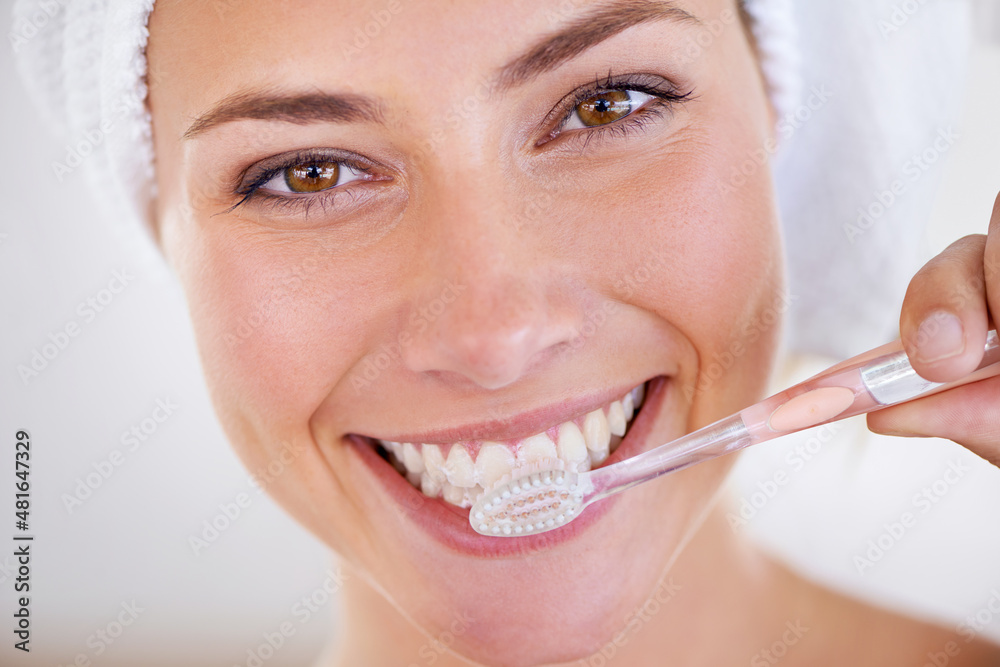 Minty freshness. Portrait of a stunning woman brushing her teeth.