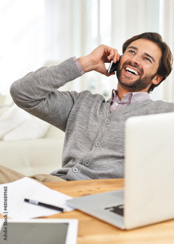 Hello, weekend Is that you. A handsome businessman speaking on his mobile at his desk.