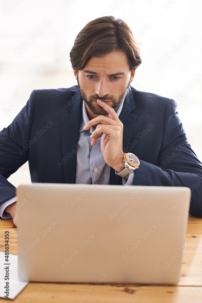 Good results require focus and patience. A handsome businessman sitting at his desk and working on h