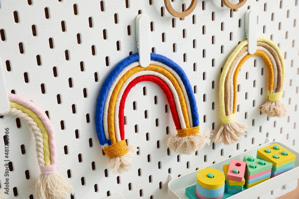 Peg board with toys in childrens room, closeup