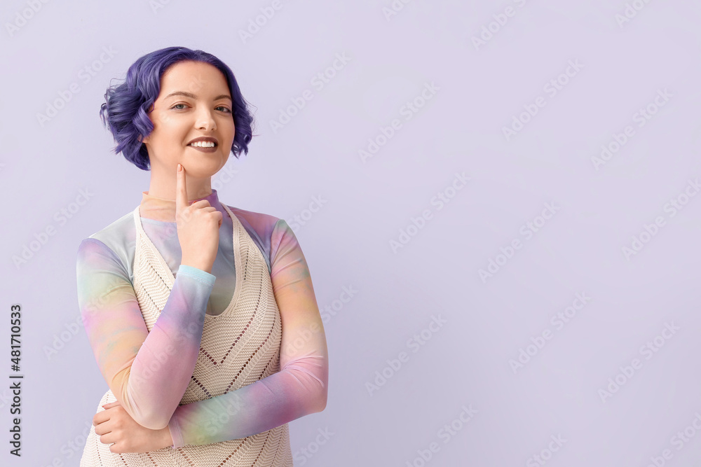 Beautiful young woman with violet hair on color background. Very Peri - color of year 2022