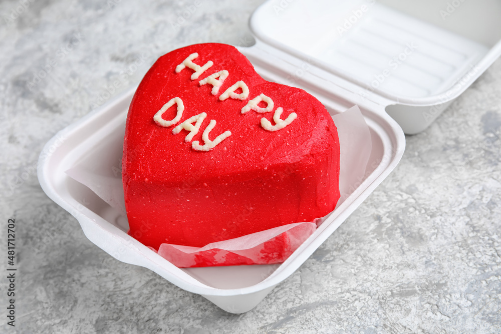 Plastic lunch box with tasty bento cake on light background, closeup