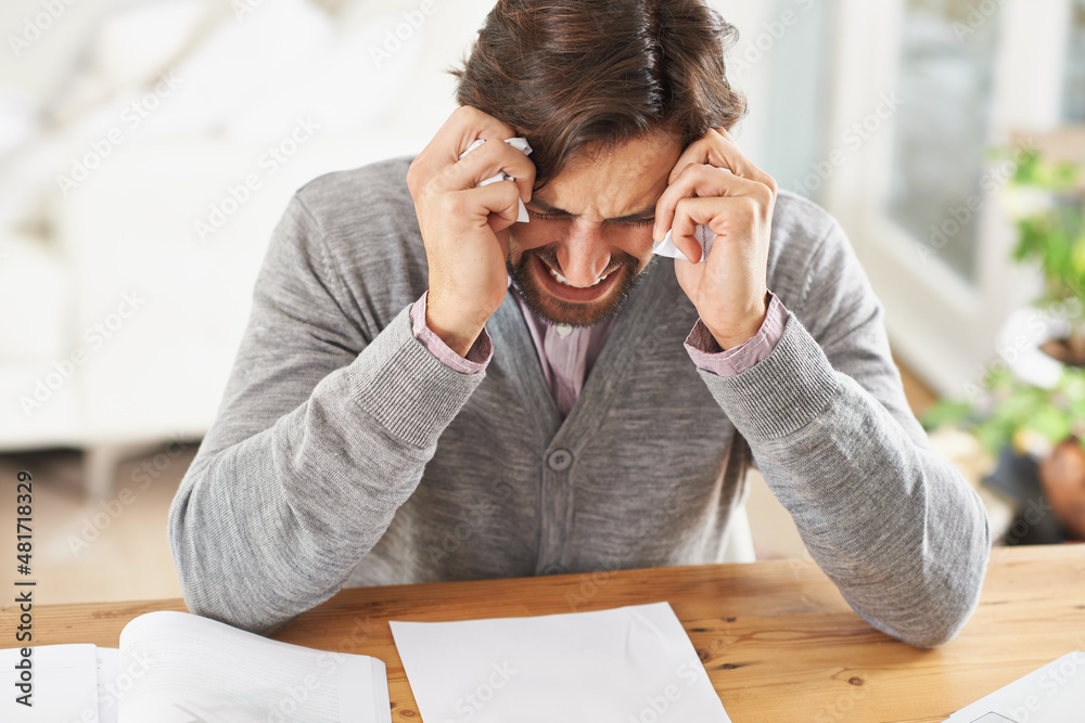 I might just cry. A frustrated businessman with his head in his hands over work stress.