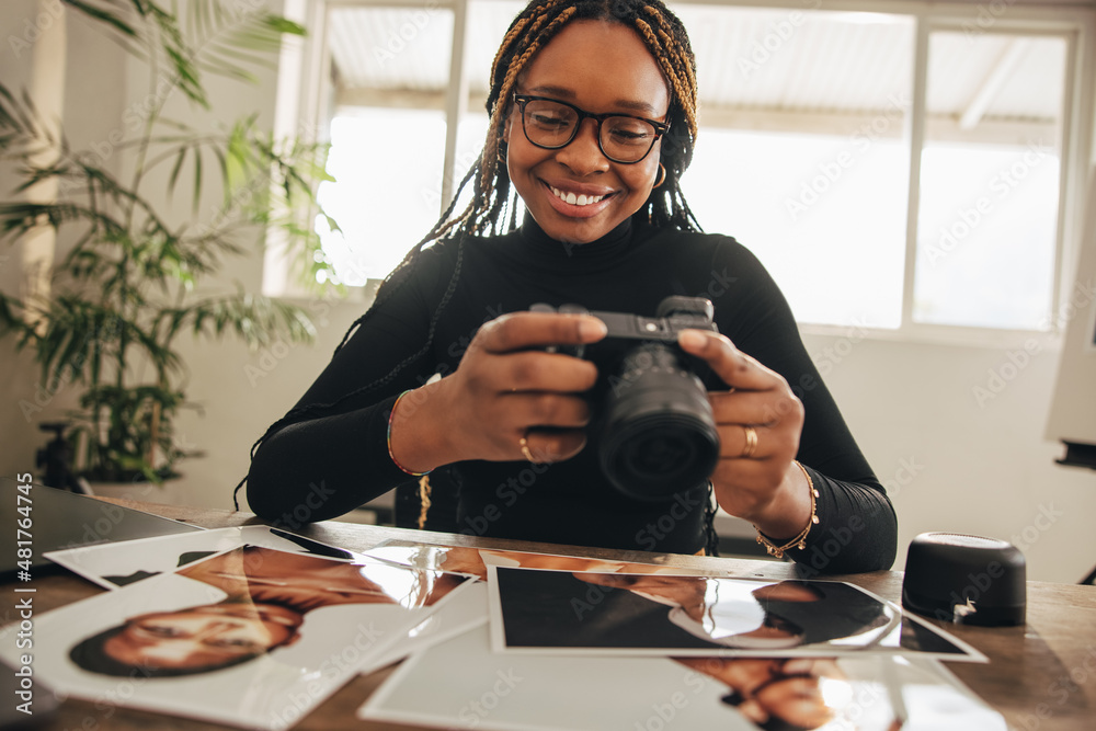 Happy young photographer holding a dslr camera