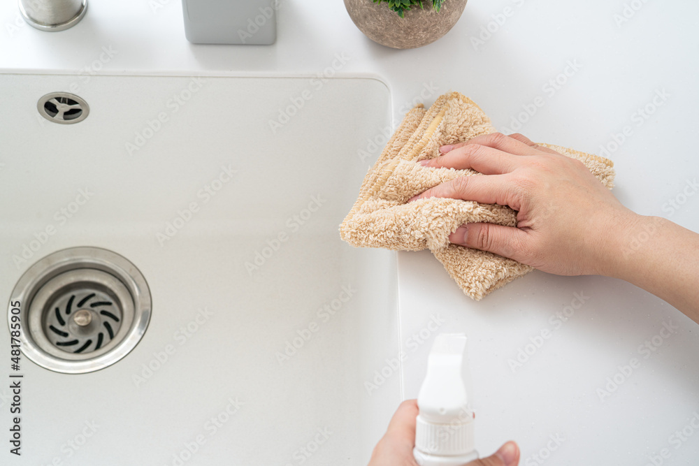 Woman housewife is doing the spring cleaning at home kitchen.