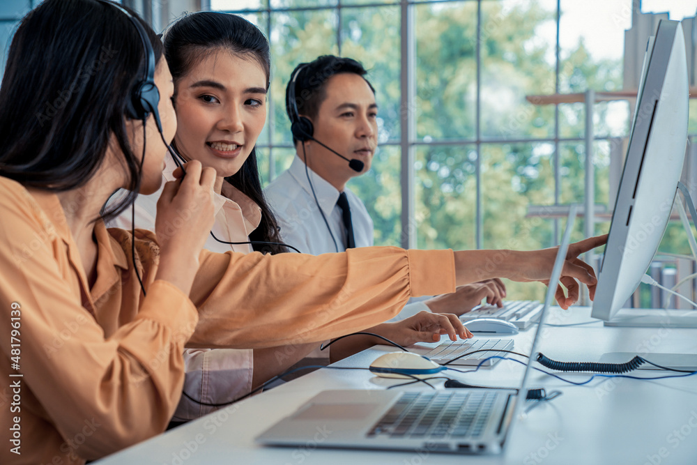 Business people wearing headset working actively in office . Call center, telemarketing, customer su