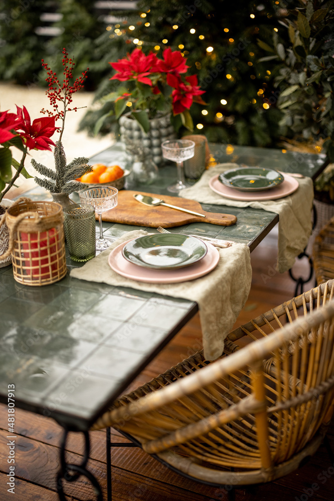 Beautifully decorated and served table for dinner at backyard on winter holidays