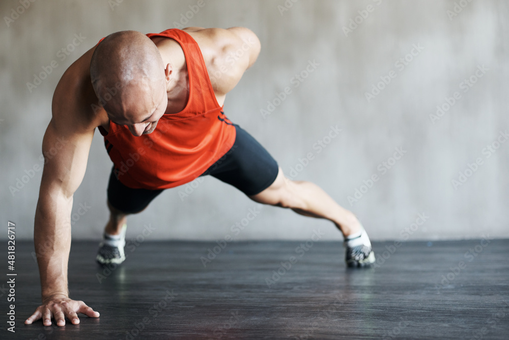 Stepping up his fitness routine. Shot of a man working out at the gym.