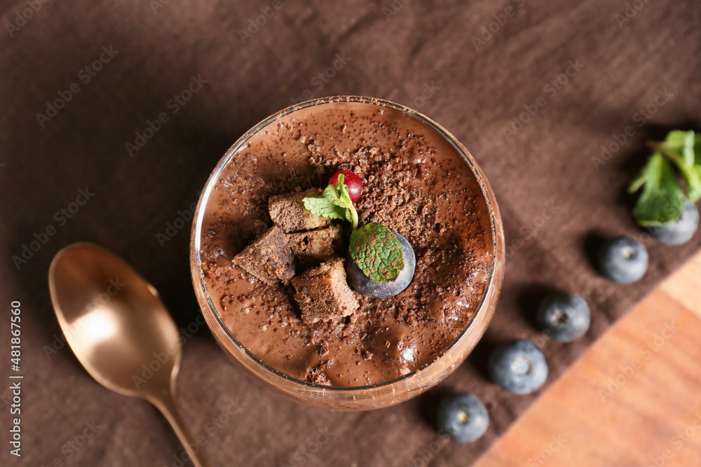 Glass of sweet cocoa dessert on table