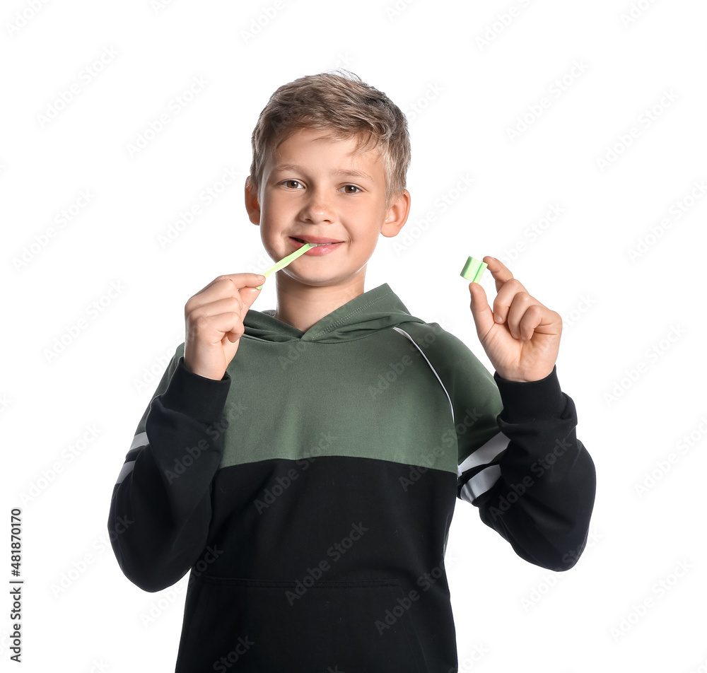 Little boy in hoodie with chewing gum on white background