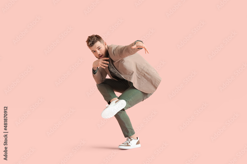 Cool dancing young man on color background